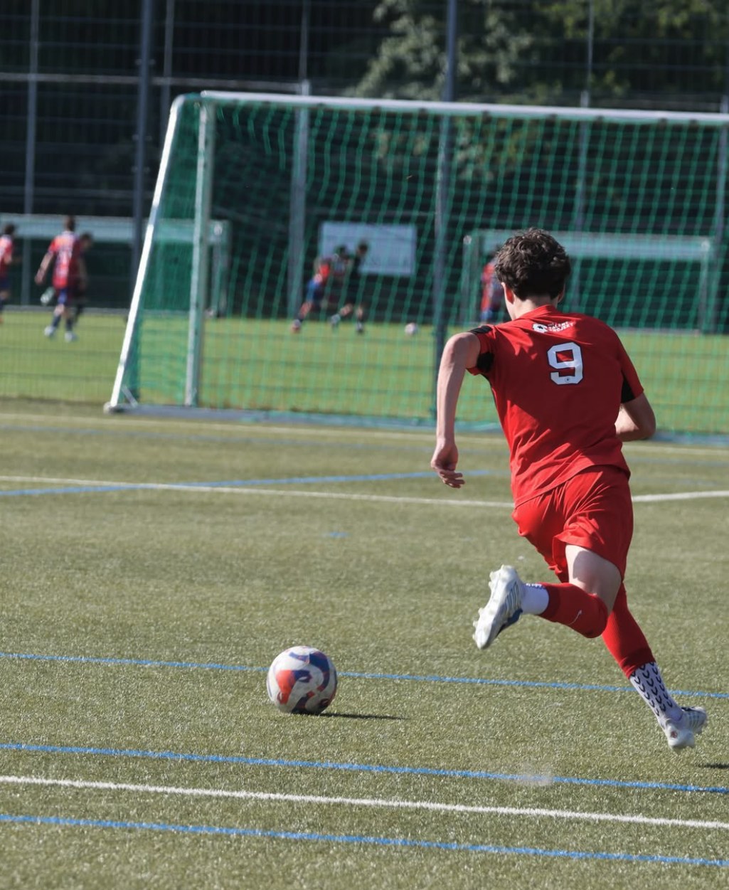 Christian Wenzel driving forward in red kit